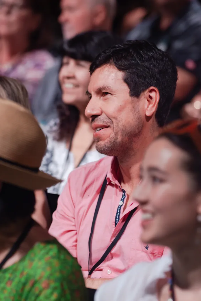 Row of smiling people sitting together