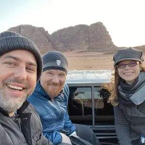 People riding behind a pickup truck in Jordan