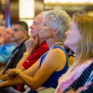 Group of people sitting together listening to a speaker